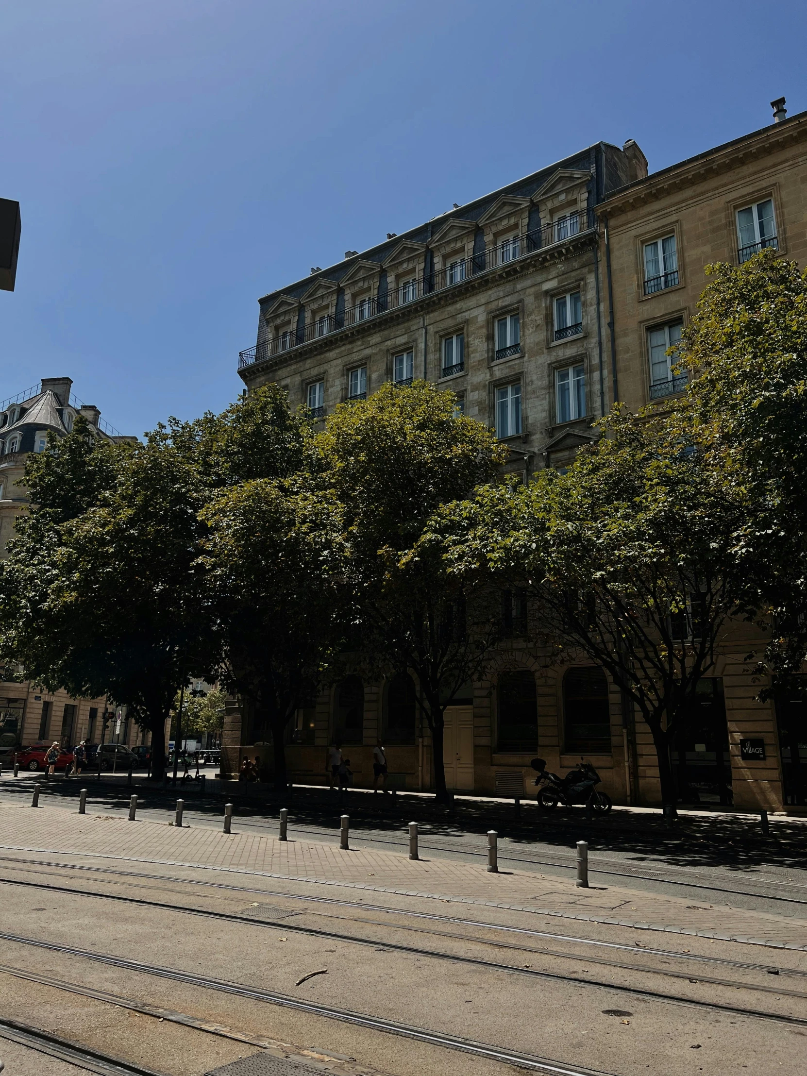 the building behind the trees is next to a train track