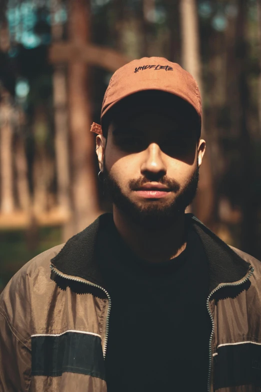 a man wearing a hat in a wooded area