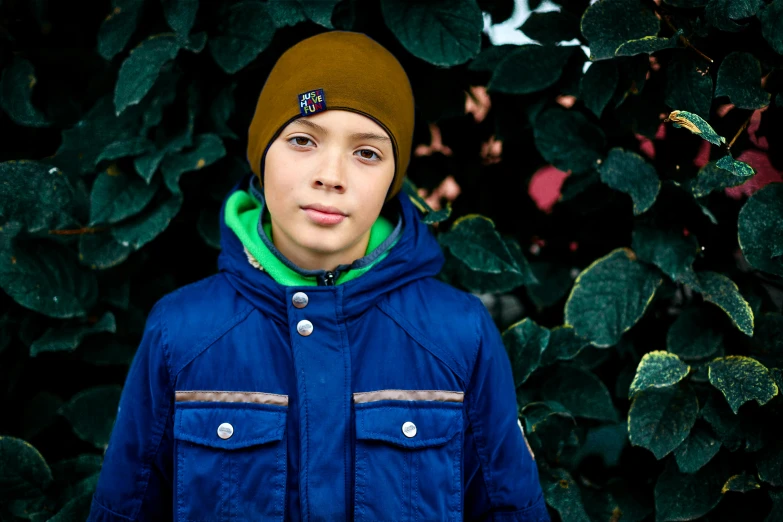 a small child is standing in front of plants