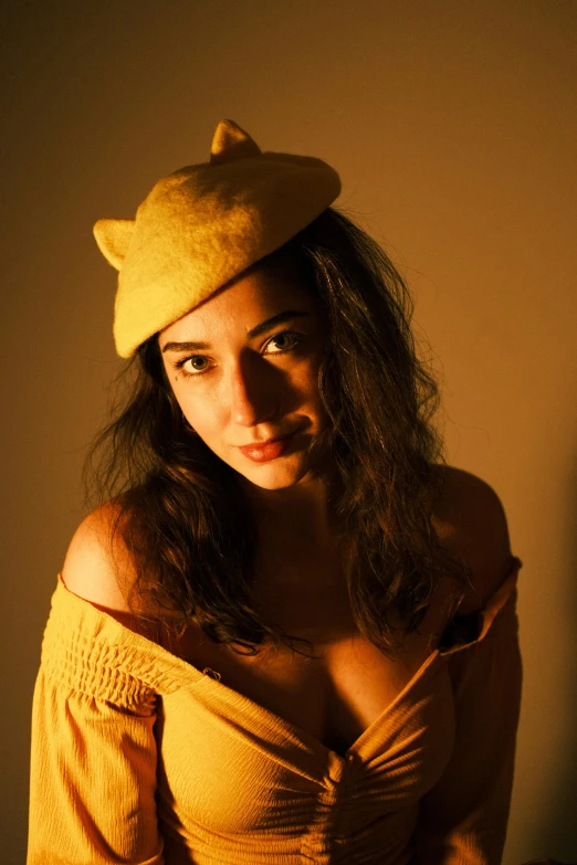 a beautiful woman wearing a cat hat while posing