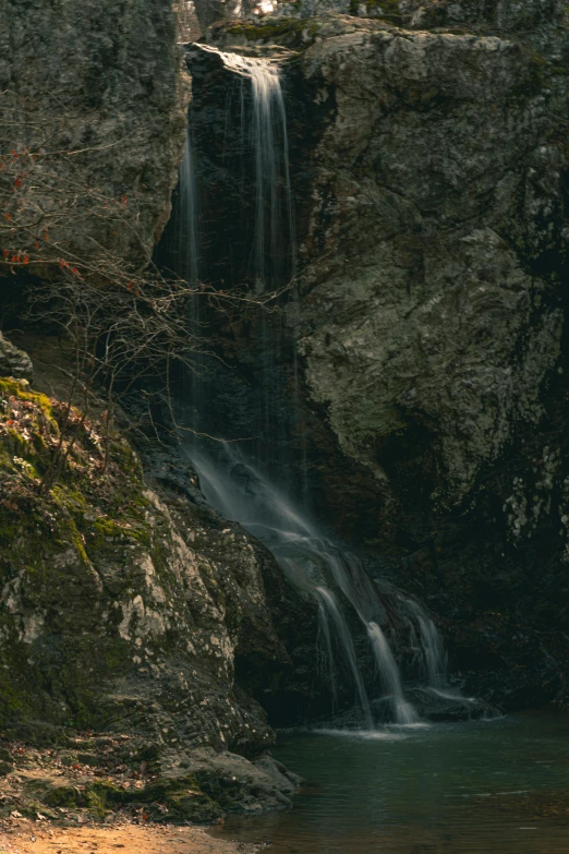 a large waterfall pouring into some water