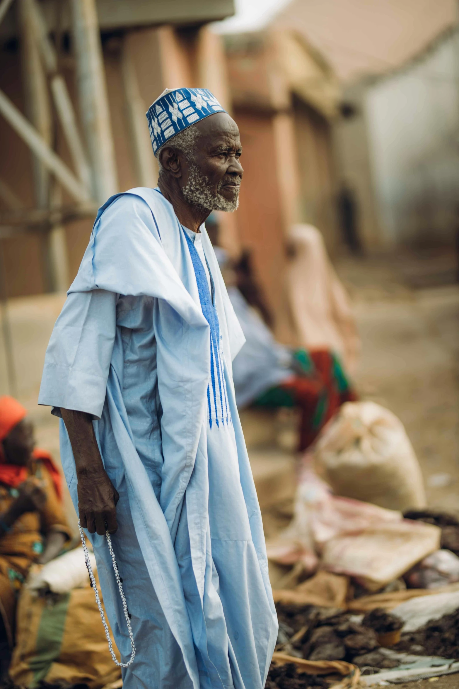 a man in a blue outfit with many items