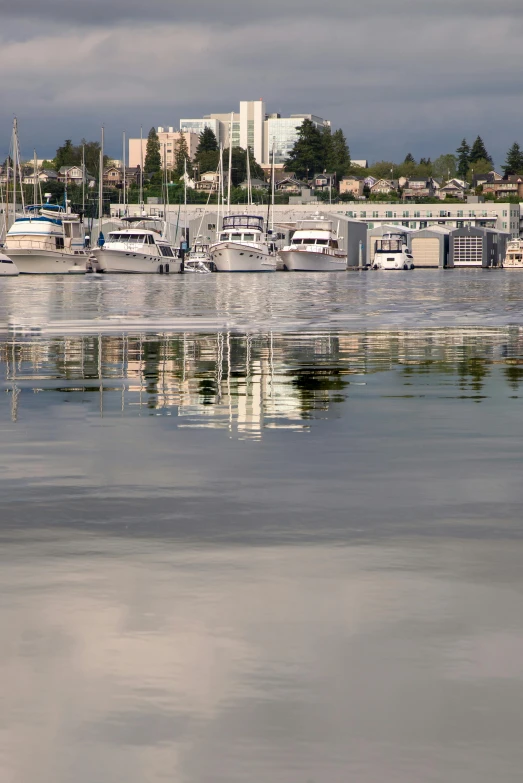 several boats on water in front of city