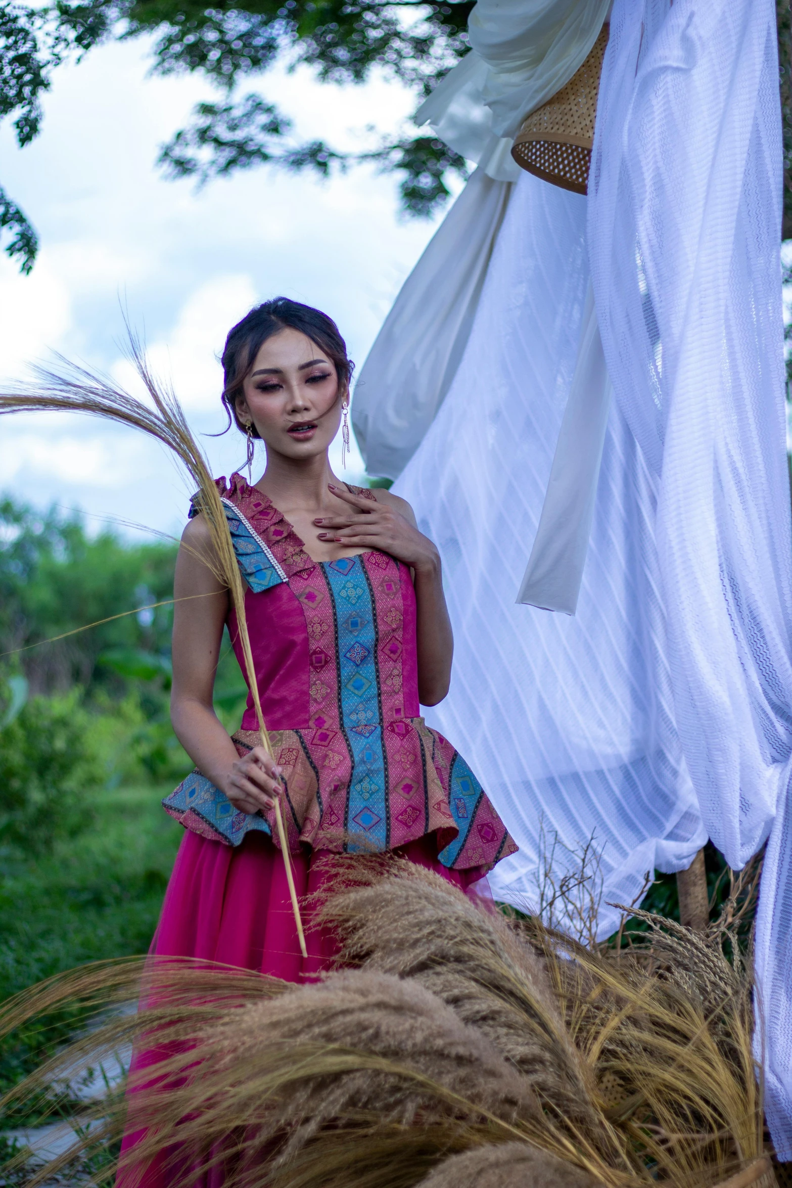 a woman in the countryside with long grass