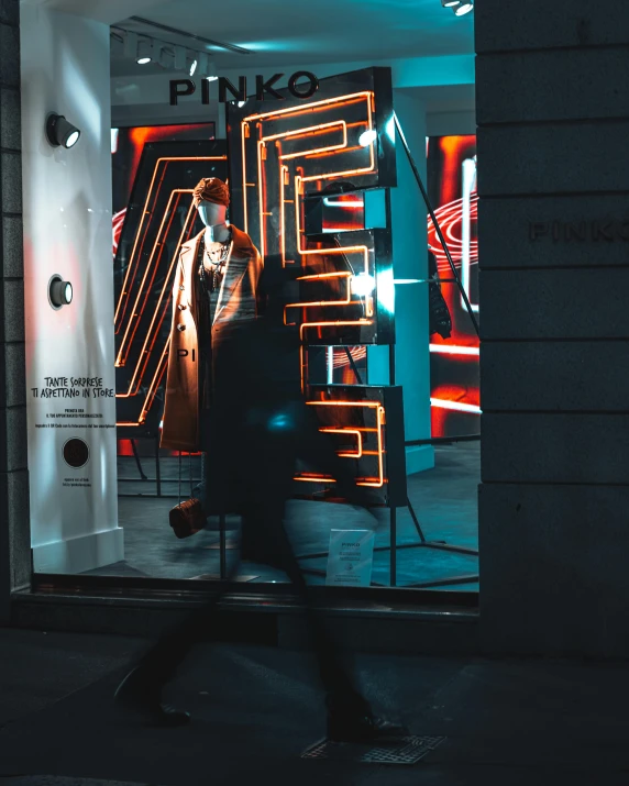 a store window with neon lights and people inside