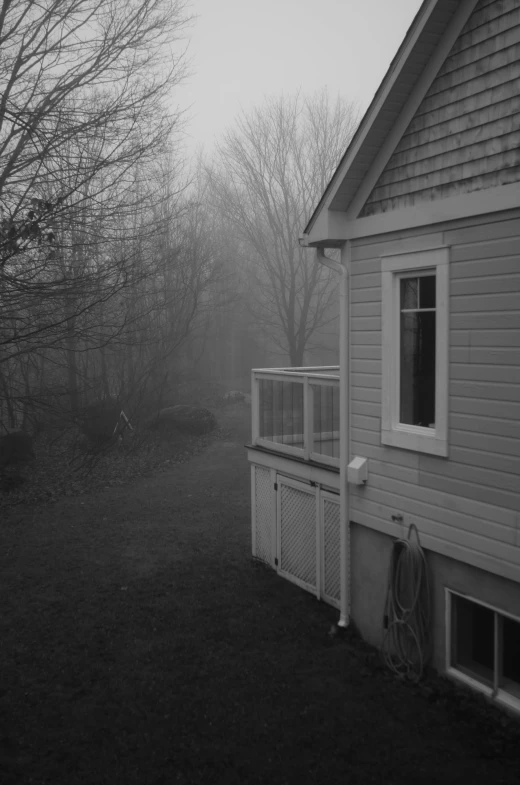 a house with fog on it and a fence