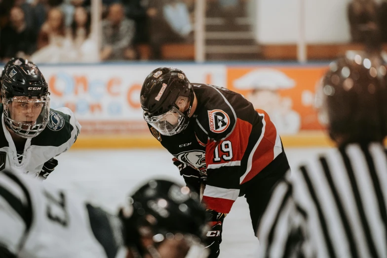 an ice hockey player looking on with one arm in the air