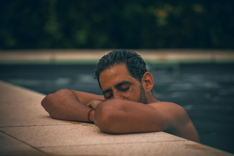 a man that is laying down in the water