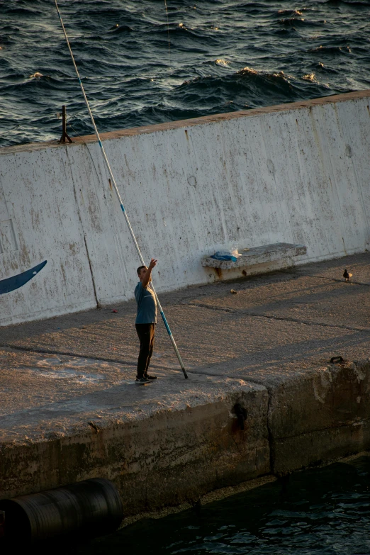 there is a man standing next to the water