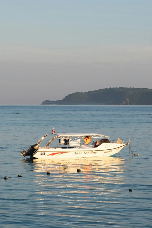 a small white boat sitting on top of a large body of water