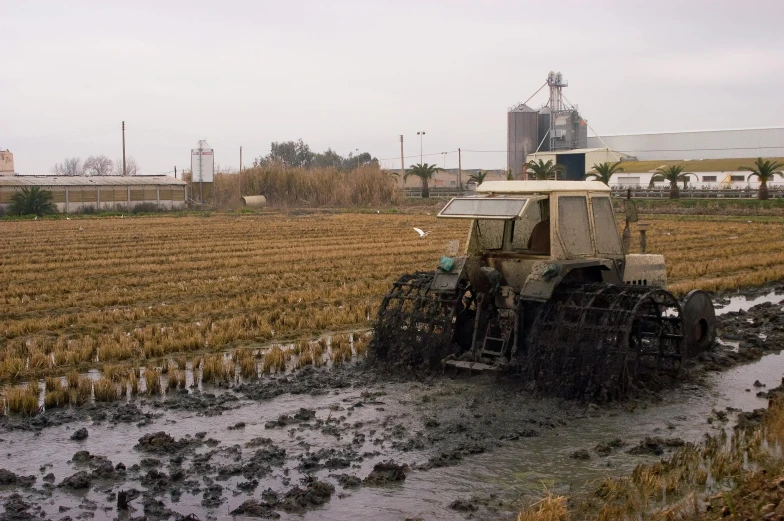 a tractor with wheels on it in a field of grass