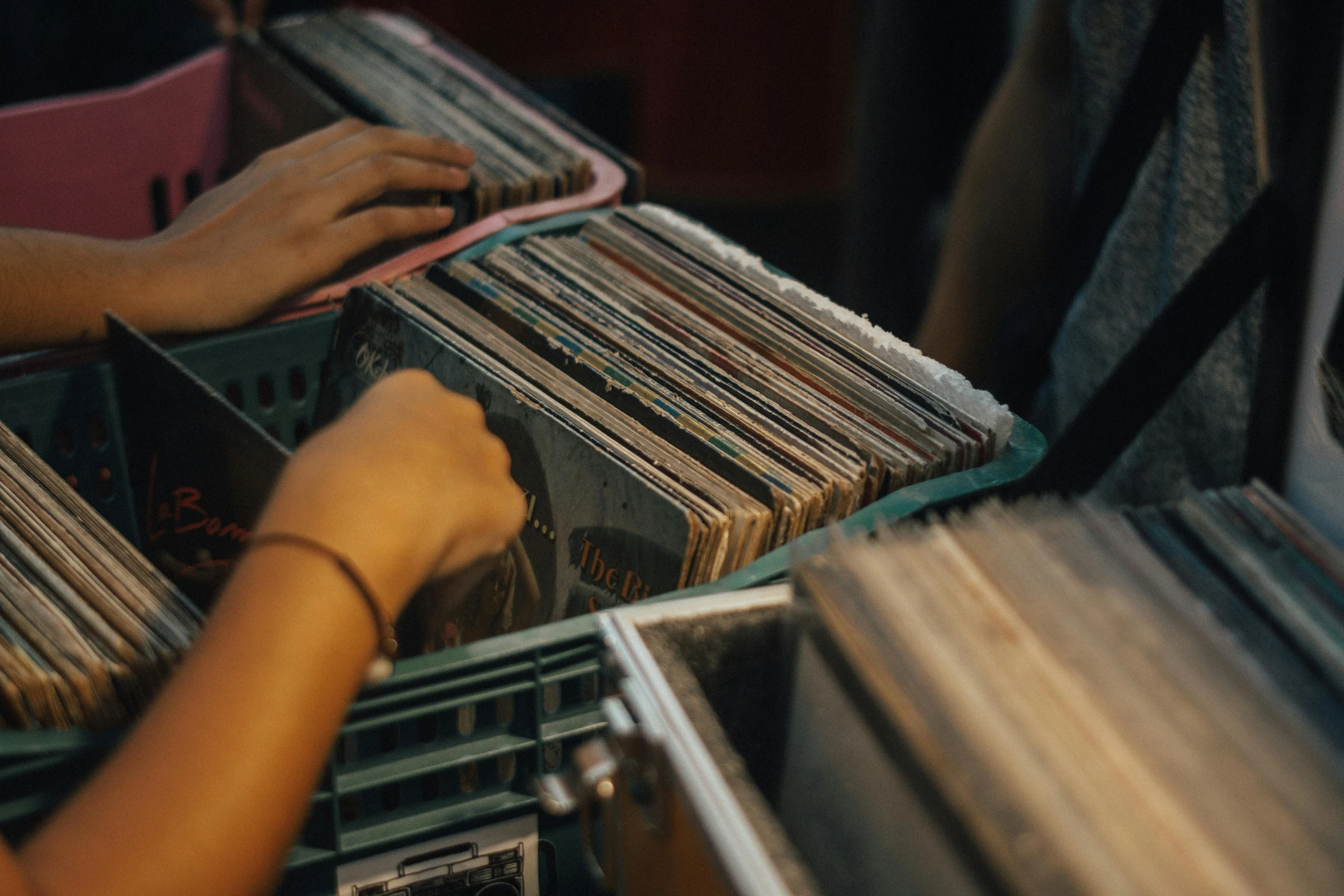 a woman in black shirt holding some records