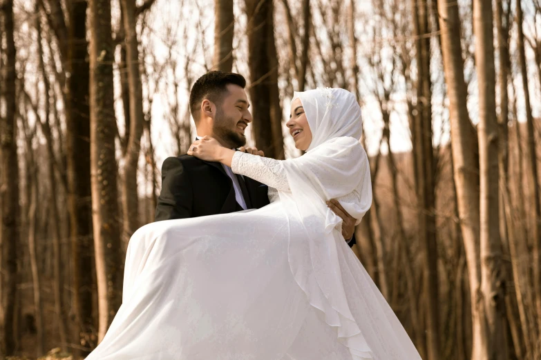 a man is carrying a woman on his back through the woods