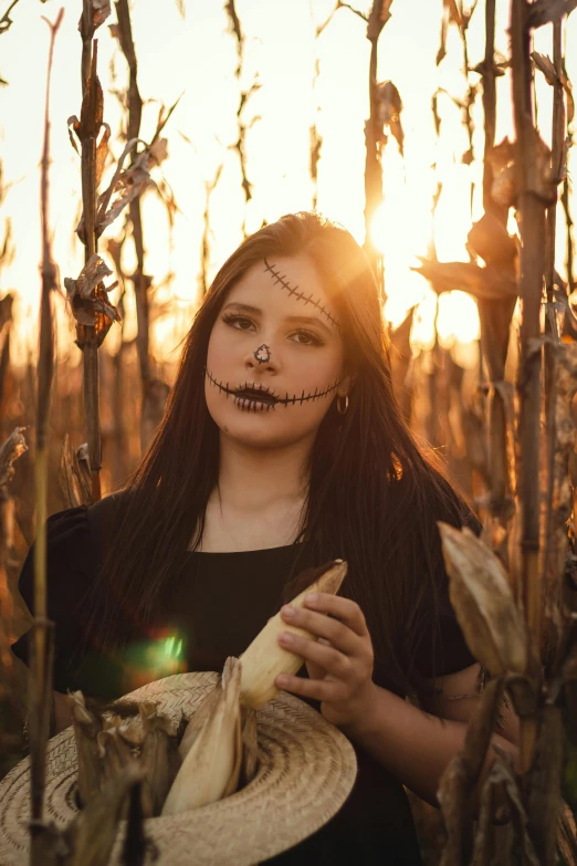 a woman with creepy makeup holding a hat