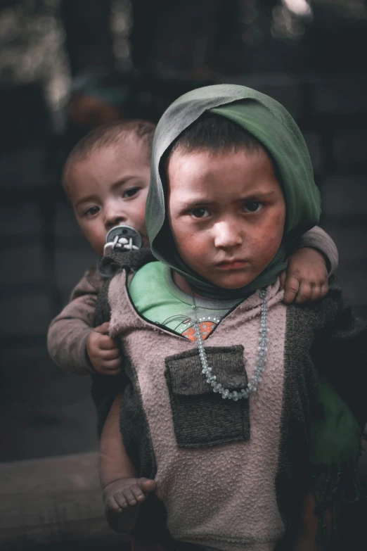 two young children holding each other in their arms