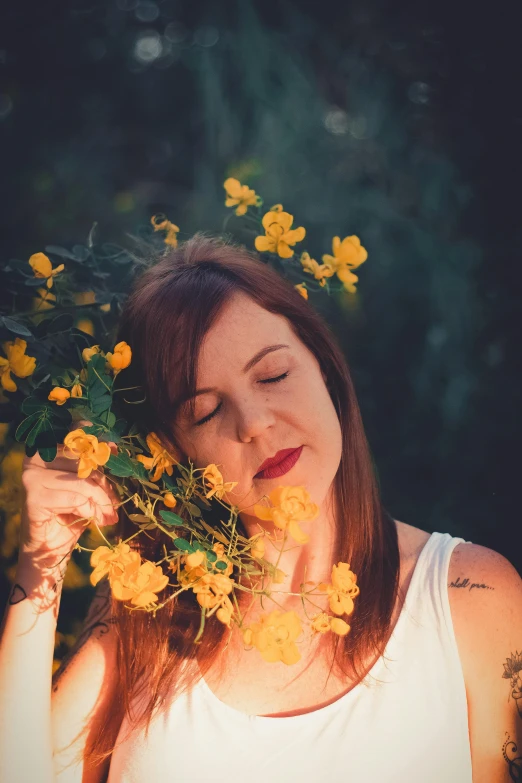 a woman holds out her flowers to her chest