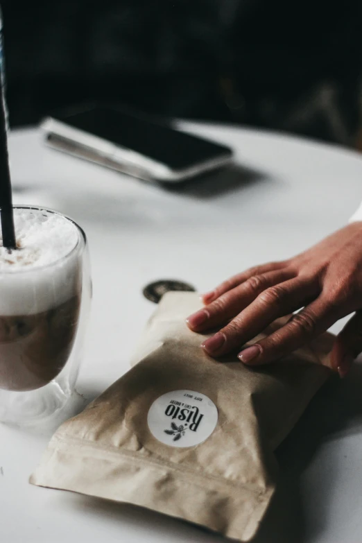 the drink has been placed on a coffee bag next to it