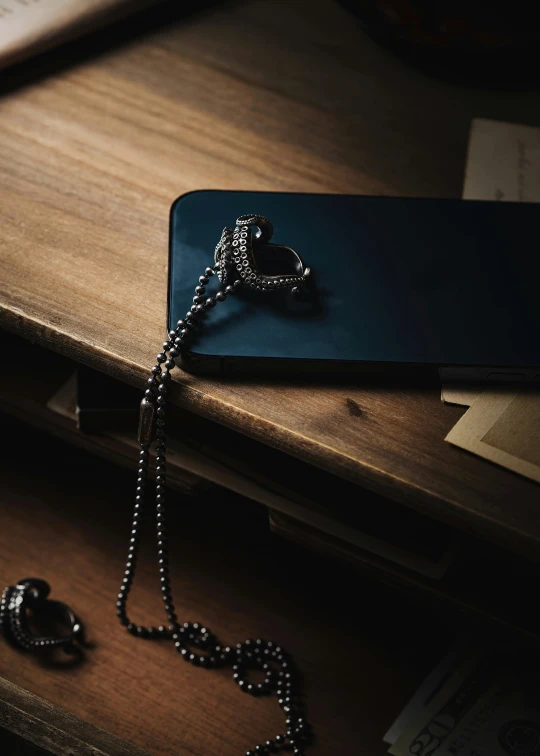 a necklace on a table next to some books