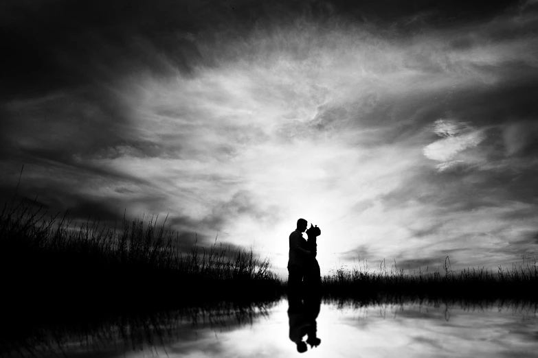 a couple kissing in the water on their wedding day