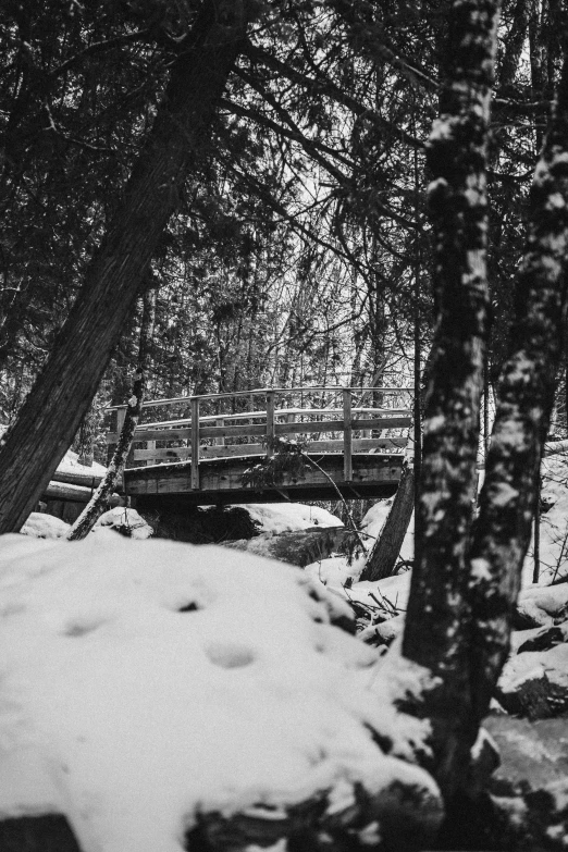 a bridge that has a small waterfall below it