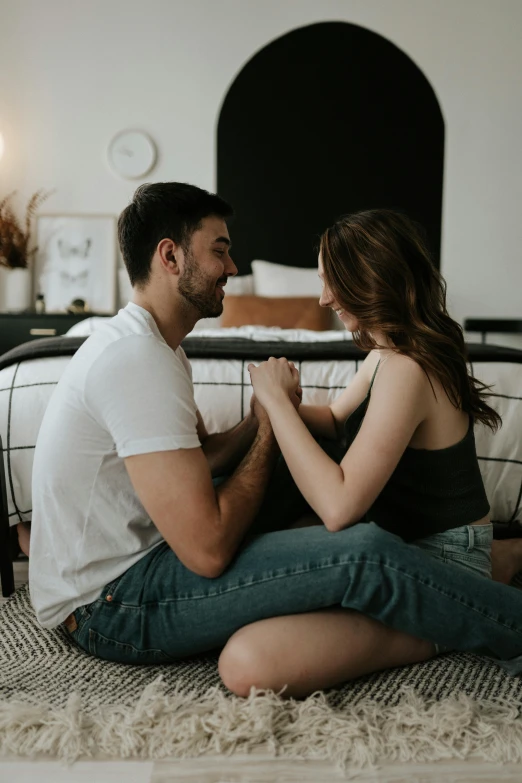 a man sitting on a woman's lap in a bedroom