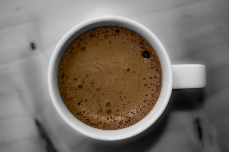 a cup of coffee on a saucer on a table