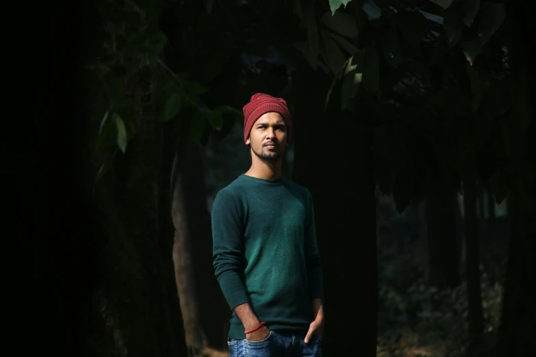 a man with a red turban is posing for a po