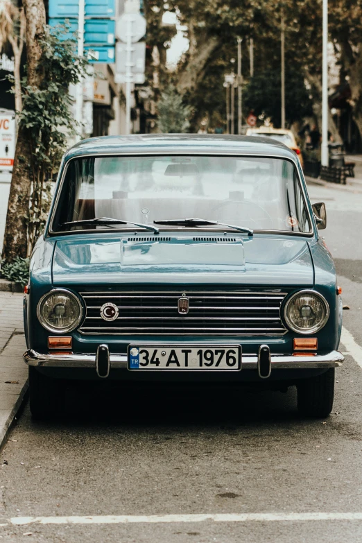 old car parked in the middle of a city street