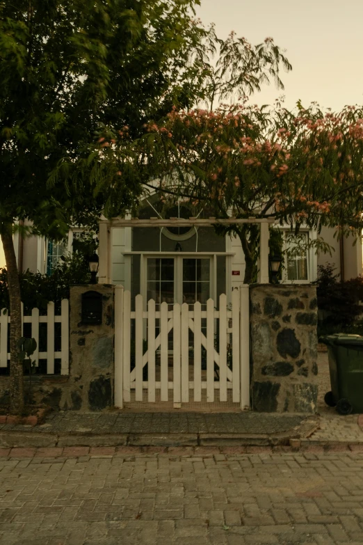 there is a small wooden gate at the front of a house