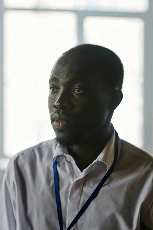 a close up of a person wearing a on down shirt and looking at the camera