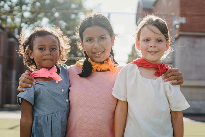 three children are posing for a po in the city