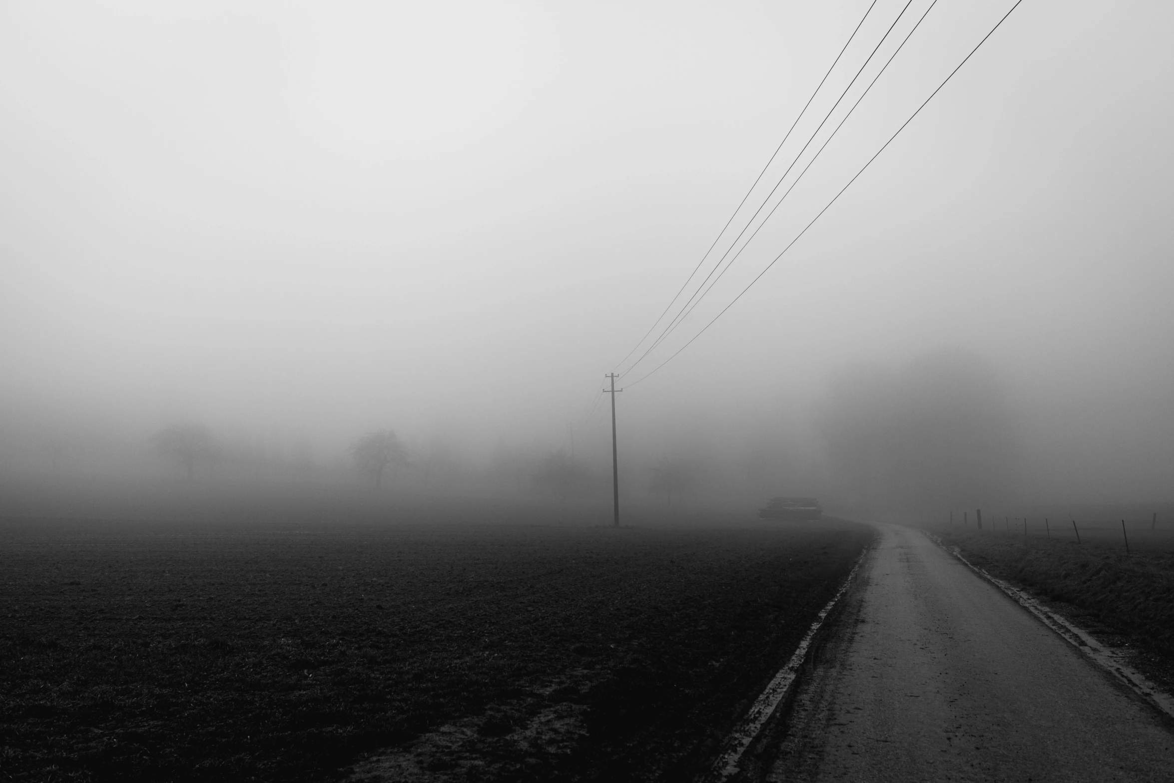 a field with power lines on the sides of it