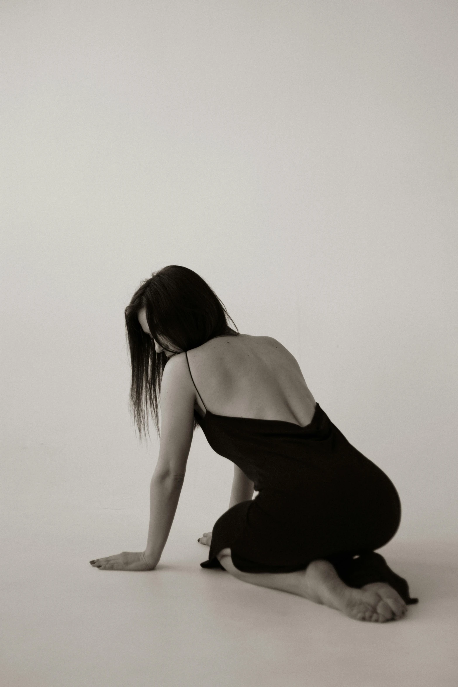 a young woman crouching in her belly as she squats