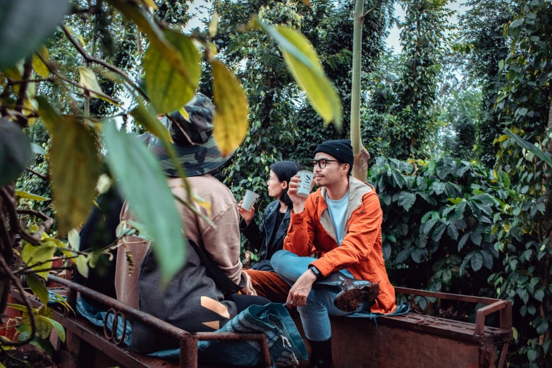 two men are riding on a boat among some plants