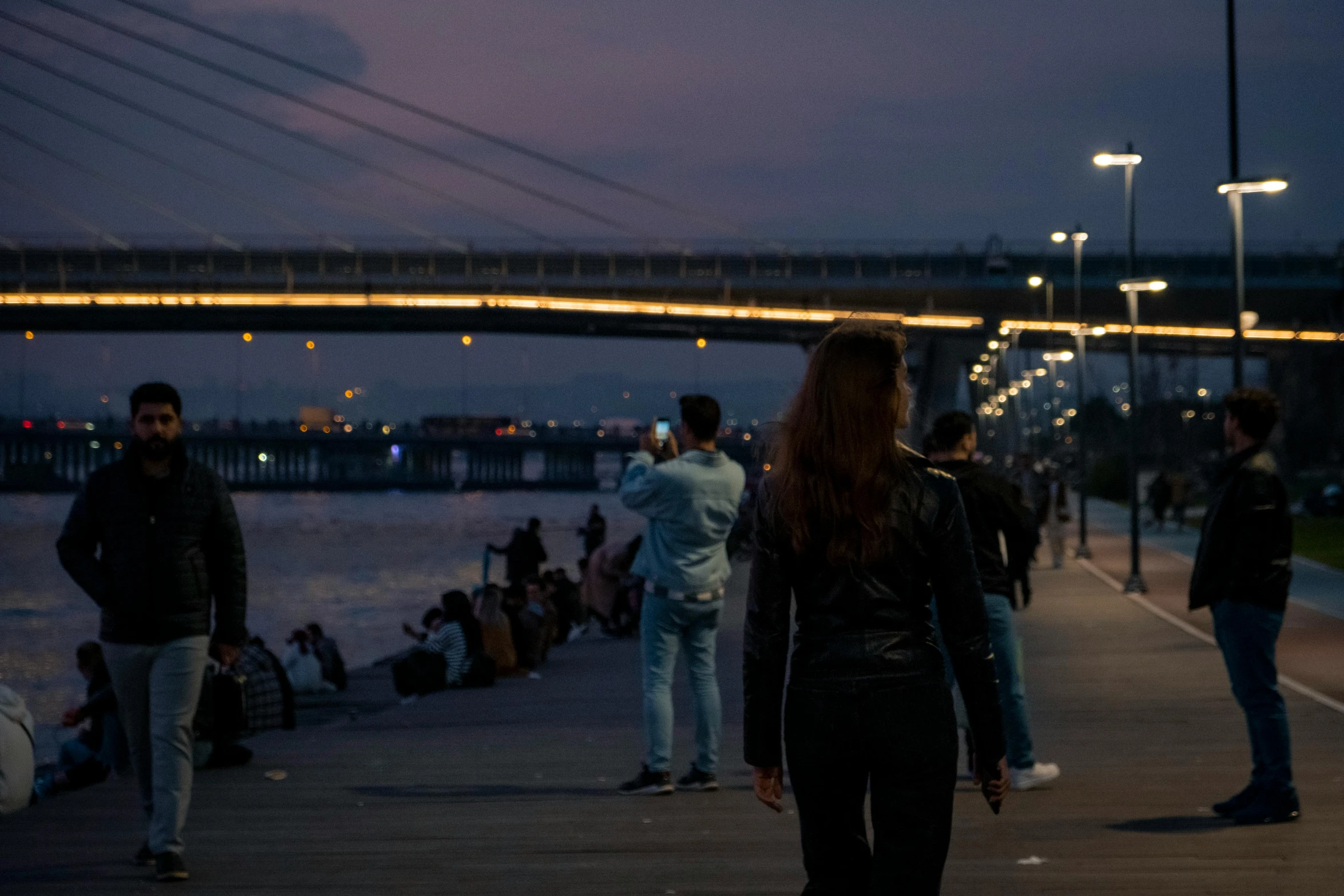 some people and a bridge on some water