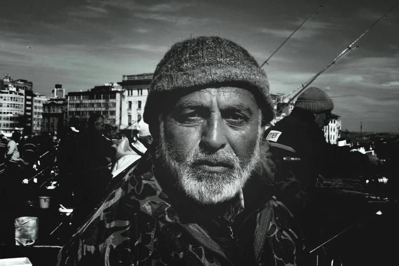 a black and white po of an old man on a boat in the ocean