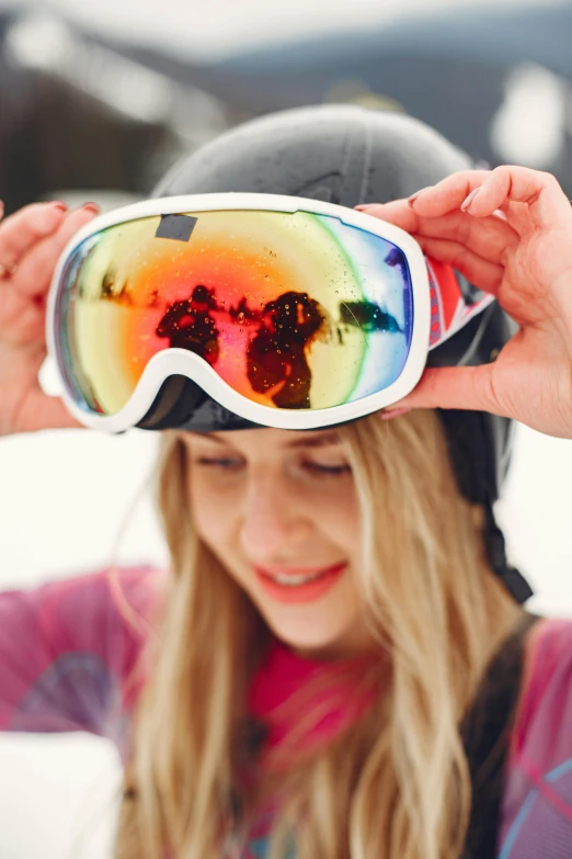 a woman wearing ski goggles over her face