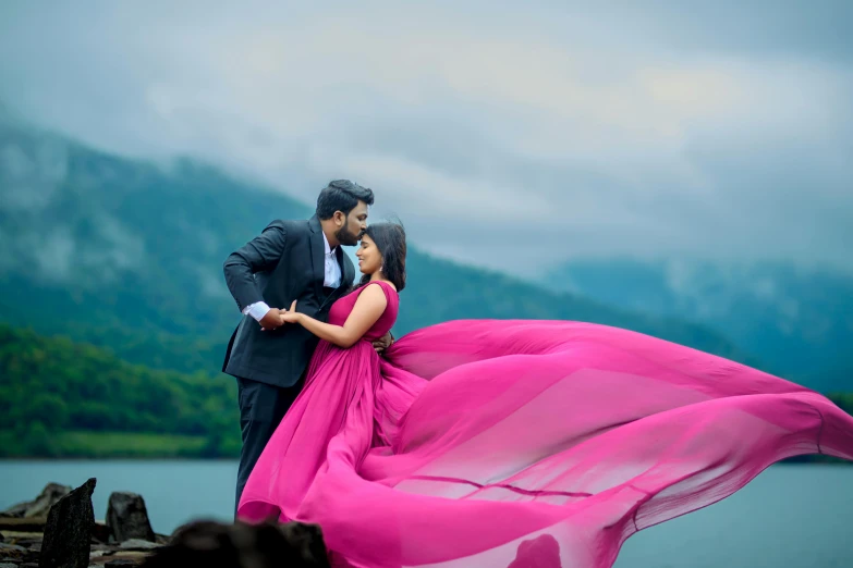 an indian couple dressed in formal wear emcing