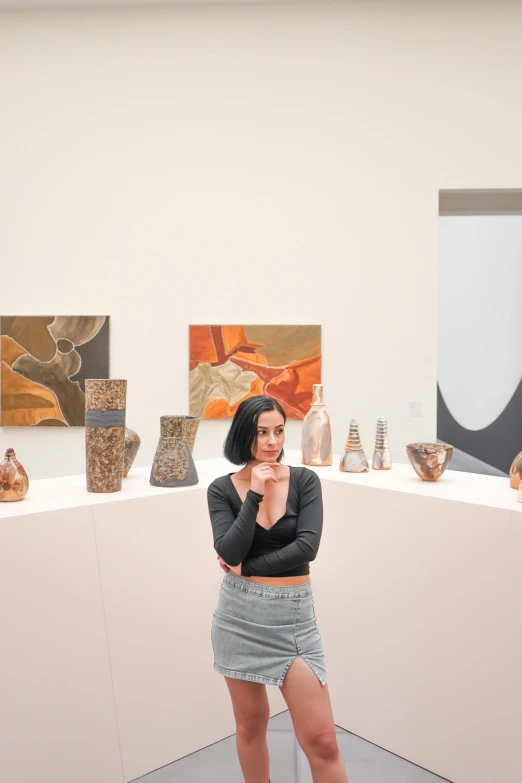 a woman is posing for a po inside a museum