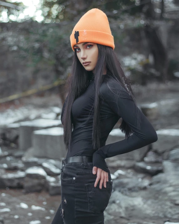 a woman in black outfit and orange hat