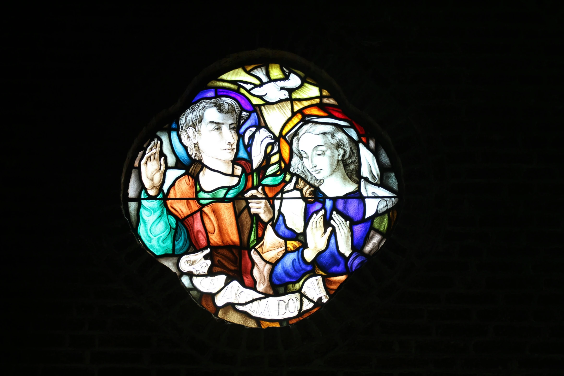 a stained glass window in the dark with people on it