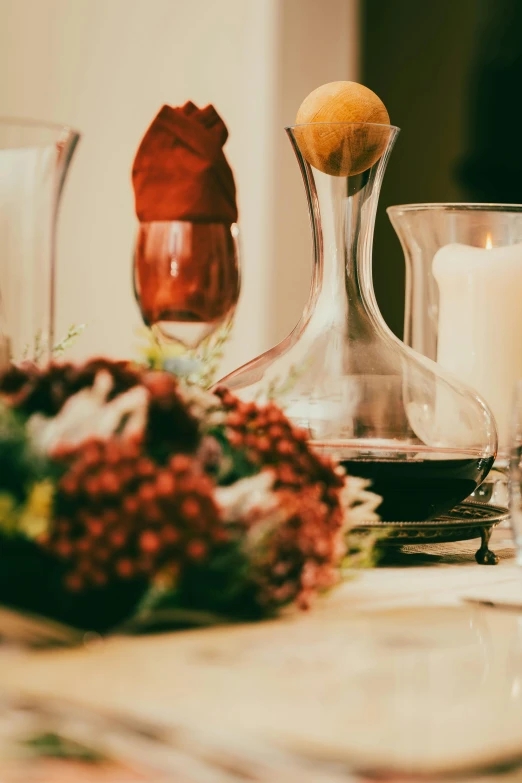 a centerpiece sitting next to two candles and a vase