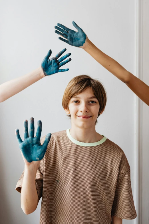 four children's hands that are painted all blue