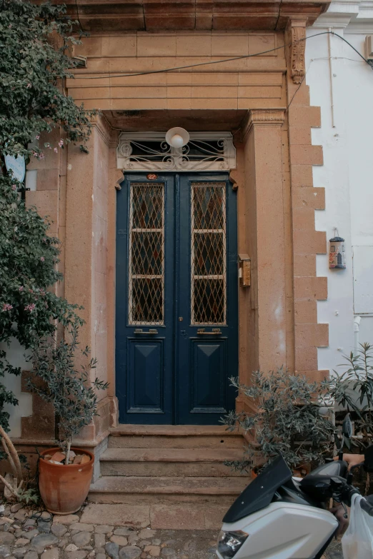 the front door of an old building with blue doors