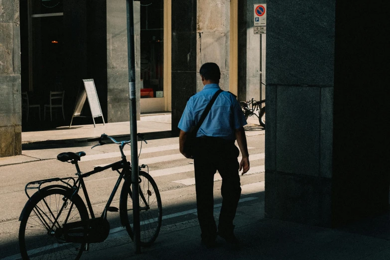 a man is standing near his bike outside