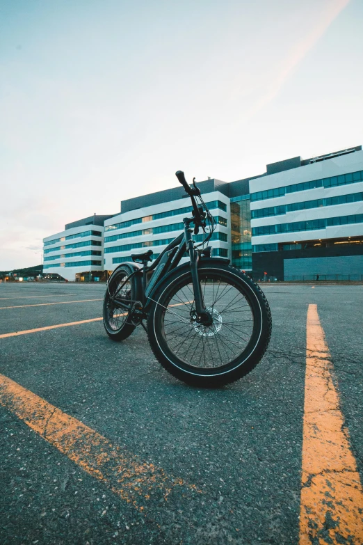 an old black bike sitting in the middle of the street