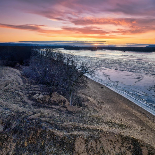 the sunset is going down at this beach