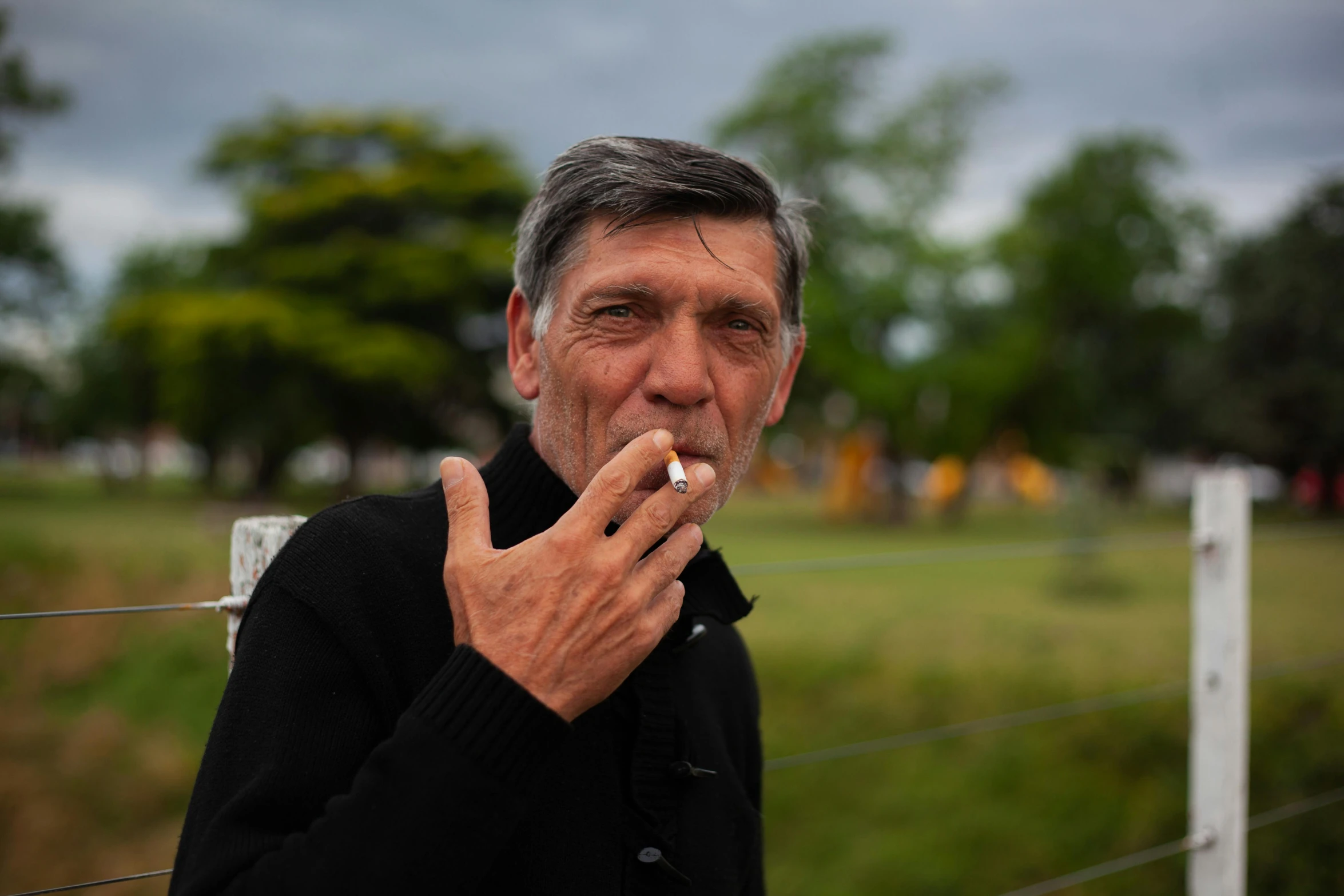 an old man with a cigarette on a street