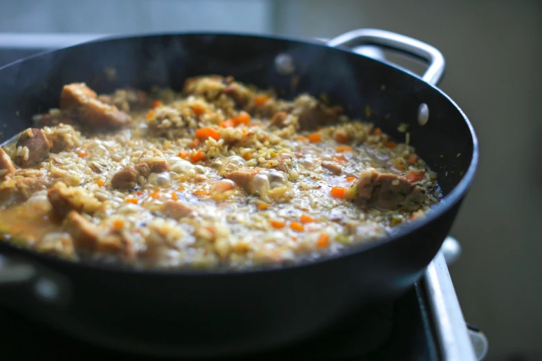 a pan of food with some meat and other things inside