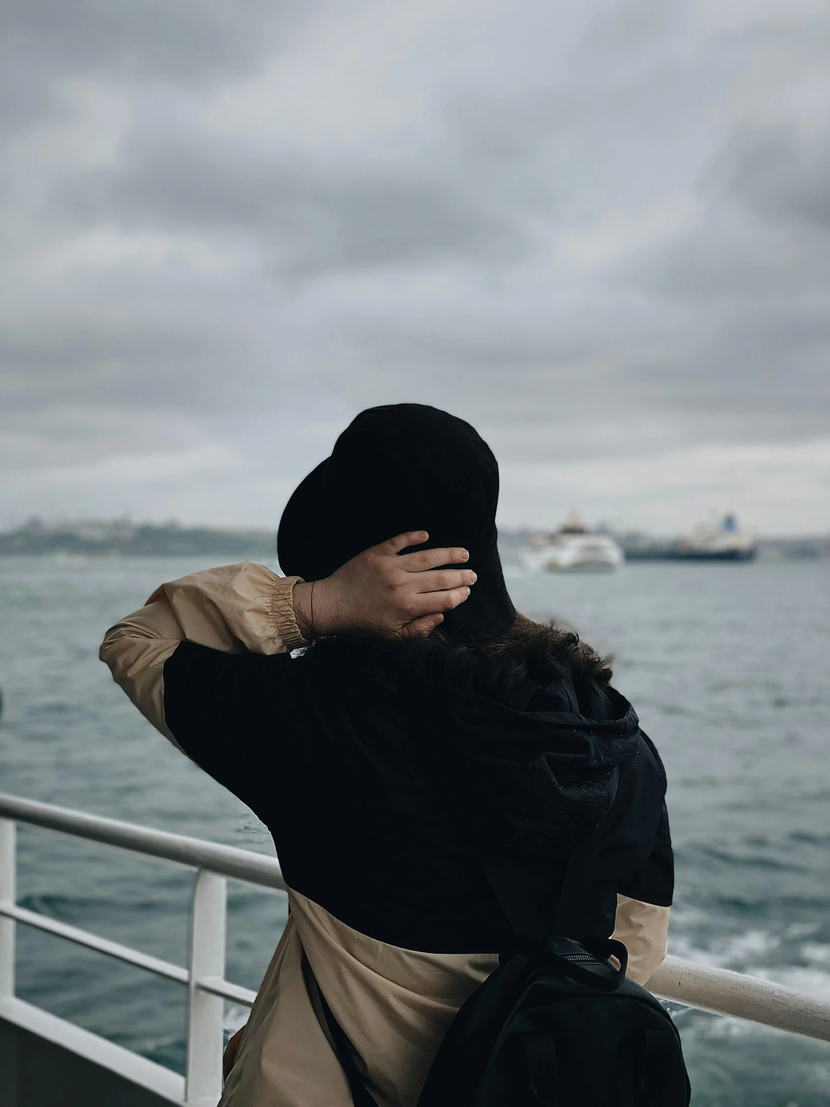 a woman standing on a boat looking out at the ocean